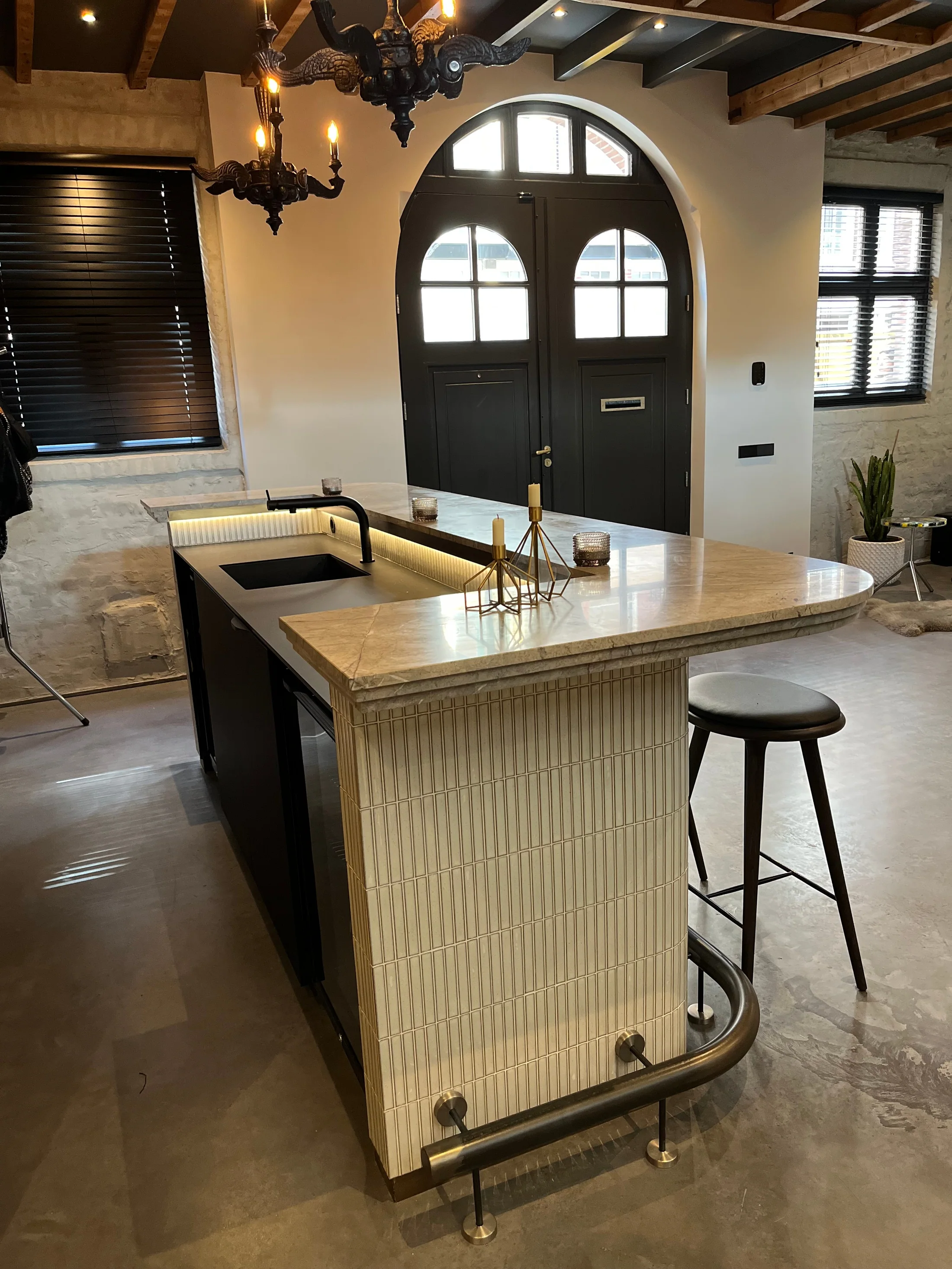 Bar met verticale tegels, natuurstenen blad en een voetsteun
